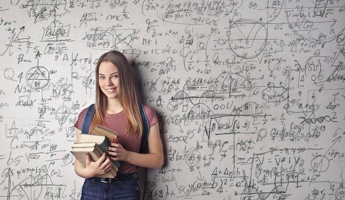 an image of a girl in front of a written white board